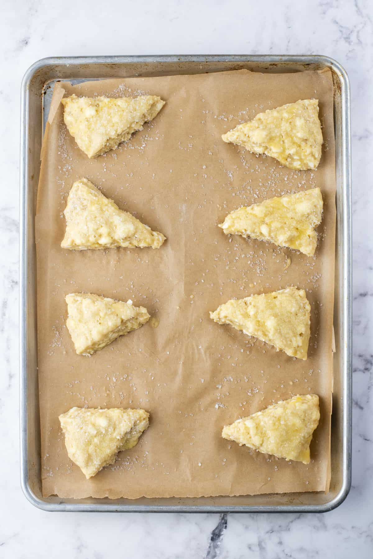 plain scones on a baking sheet lined with parchment paper